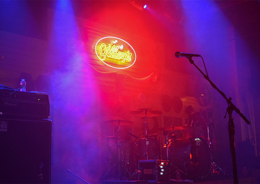 Image of gilleys neon sign behind stage